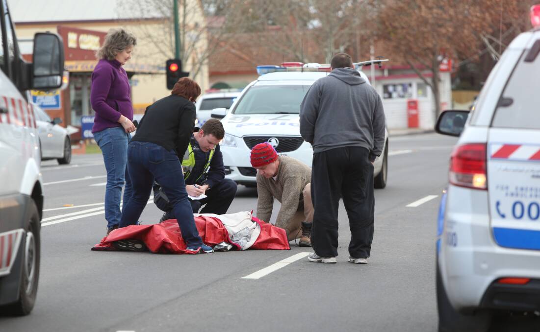 ACCIDENT: Paramedics treat a woman hit by a car in Golden Square. Picture: GLENN DANIELS