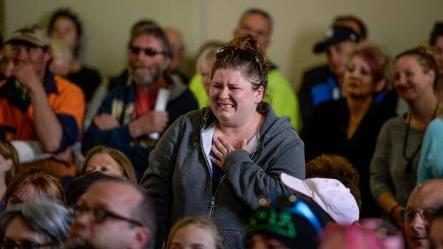 An emotional local woman asks about her house and pets. Photo: Justin McManus

