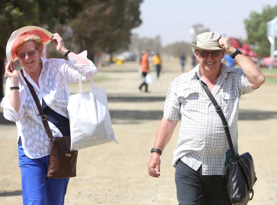 HOLD ONTO YOUR HATS: Francis and Ronald Elliott, from Arthurs Creek battle against the wind and heat at the Elmore Field Days. Picture: GLENN DANIELS