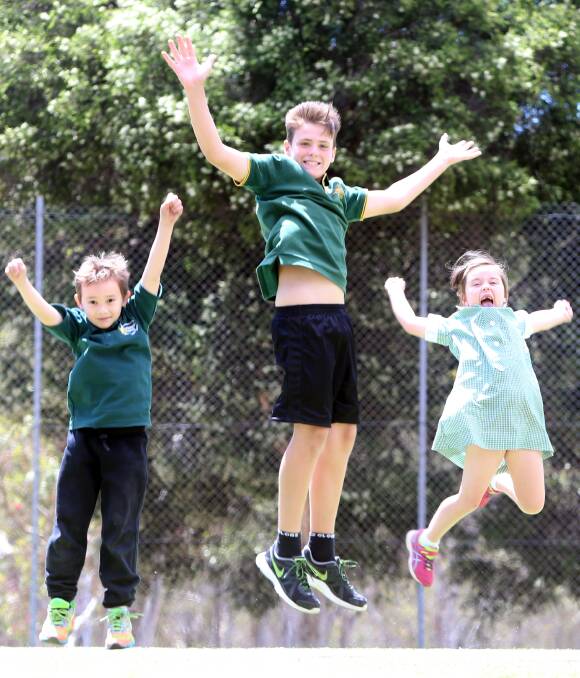JUMPING FOR JOY: Spring Gully Primary School students Jayden Evans (left), Campbell Smith (centre) and Matilda Clohesy (right) celebrate their fundraising success. Picture: GLENN DANIELS