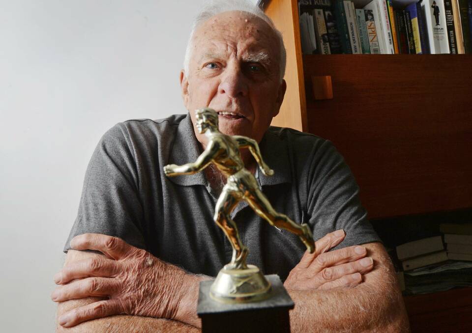 VICTORIOUS: The sprightly 84-year-old looks fondly upon the trophy he won at the Victorian Country Marathon 50+ section in 1982, which was held in Bendigo.