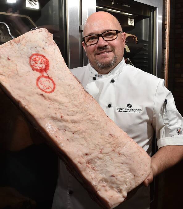 QUALITY: Paul Pitcher with a piece of steak from his restaurant. The Woodhouse was named the third best steak restaurant in Australia at the Savour Awards on Monday.