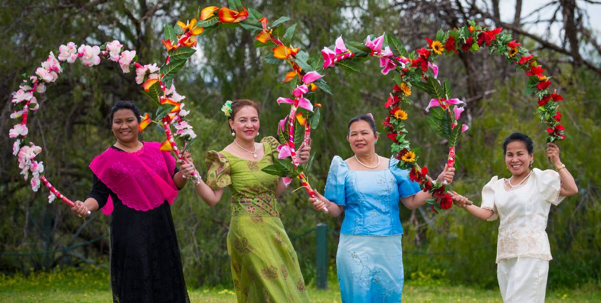 FLOWER POWER: Ann Gittins, Luchie Hull, Myrna Armstrong and Josie Jolly perform a traditional Filipino flower dance. Picture: SEAN PLETA PHOTOGRAPHY