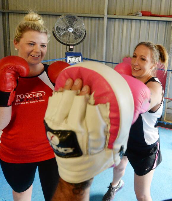 Generosity: Beck Ferrier and Nicole Molloy practice ahead of the fundraiser for Jenny Tate at Punches in Bunches. Picture: DARREN HOWE