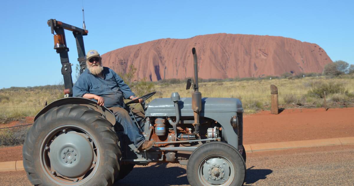 TRIP OF A LIFETIME: Maiden Gully man Bob Wilson takes time out from his 2500-kilometre journey from Western Australia to Alice Springs in his 1956 Harry Ferguson tractor to take in the iconic Uluru. 