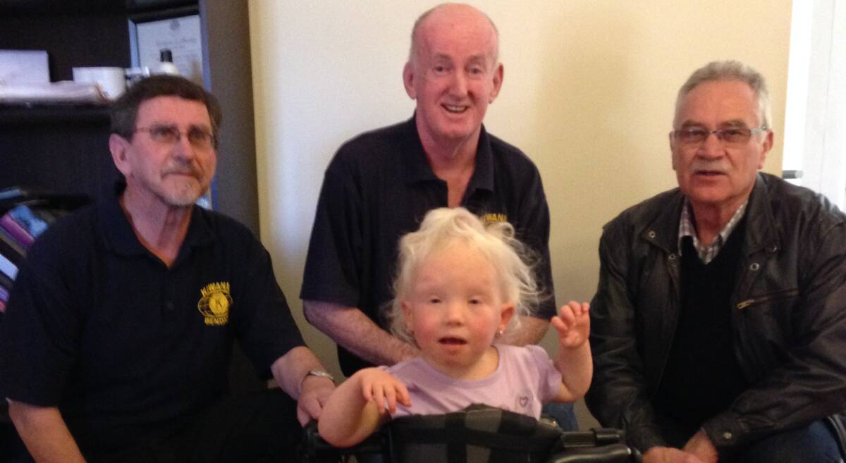 DONATE: With a happy Lexie is from left Alan Darby, Ron Crowe and Ross Spedding.
