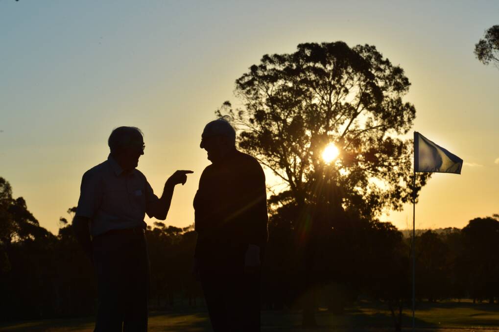 Two people talk on a golf course in the Bendigo area. Picture by Brendan McCarthy