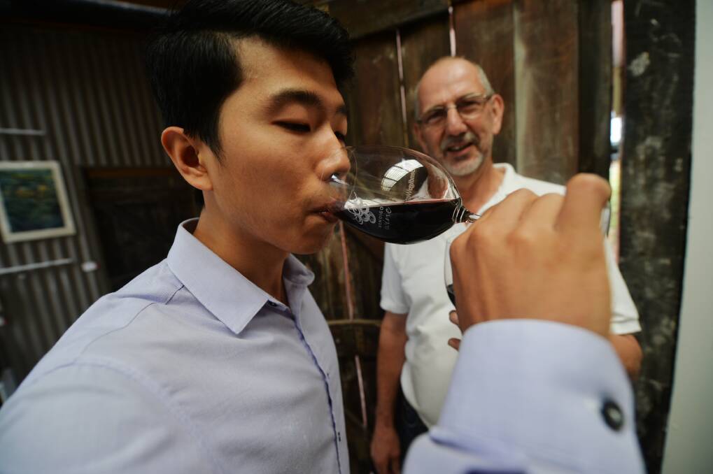 Wish this was your job? Winemaker Peter Fyffe watches as Dr Pangzhen Zhang hunts for a peppery flavour prized by Chinese connosiours . Picture: Darren Howe