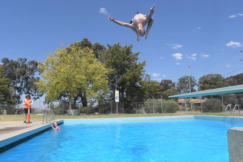 Andrew Bramley dives in at the Brennan Park pool. Picture: NONI HYETT