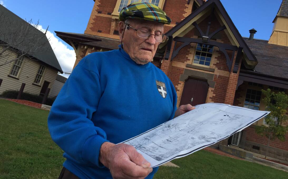 LOOKING FOR HISTORY: George Ellis studies a copy of a historic Long Gully map at CVGT Australia's Long Gully premise, where a new plaque has been installed.