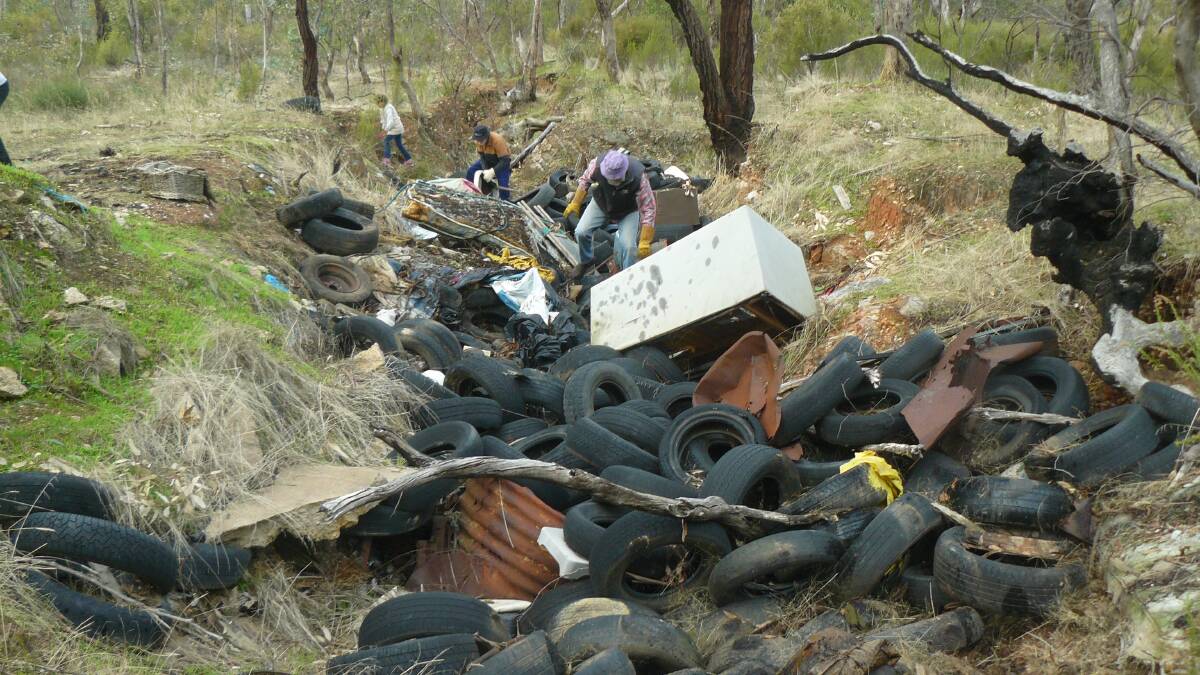 CLEAN UP TO CONTINUE: Volunteers clean up a ditch in the bush after it was filled with illegally dumped waste.
