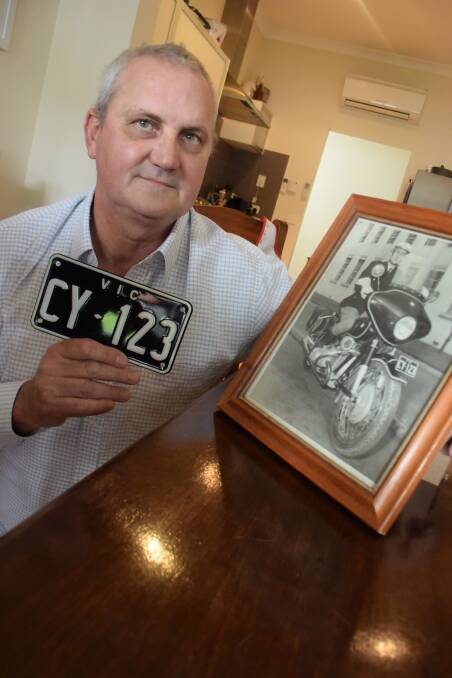 FAMILY TIES: Stuart Stow with the number plate from his first motorbike. The registration number was the same as the one on his father's patrol bike. Picture: TOM O'CALLAGHAN