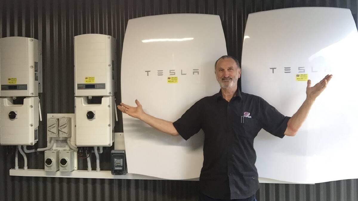 POWERING UP: SB Solar Battery Services manager Stephen Breheny with a Tesla battery capable of storing enough power for half some households' daily energy use. Picture: CONTRIBUTED