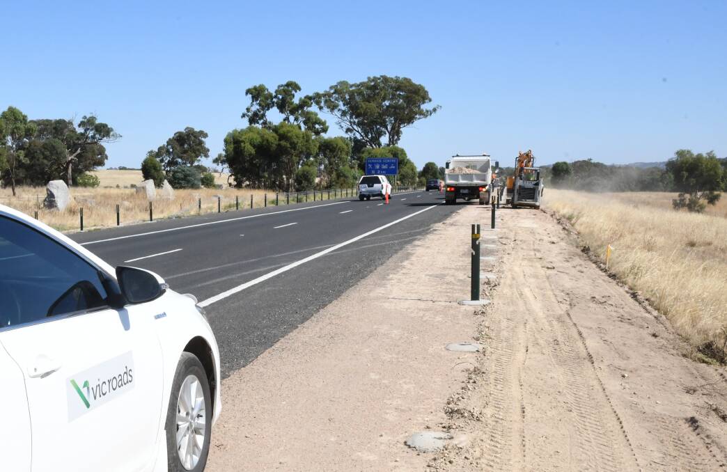 Wire rope barriers being installed along the Calder Highway at Ravenswood South last month. Picture: ADAM HOLMES
