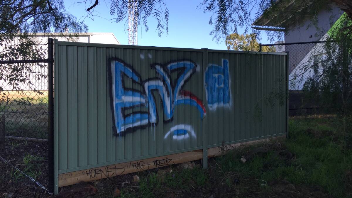 VANDALISM: Police are investigating after this fence at the rear fence of the Kangaroo Flat fire station was graffitied at the weekend.