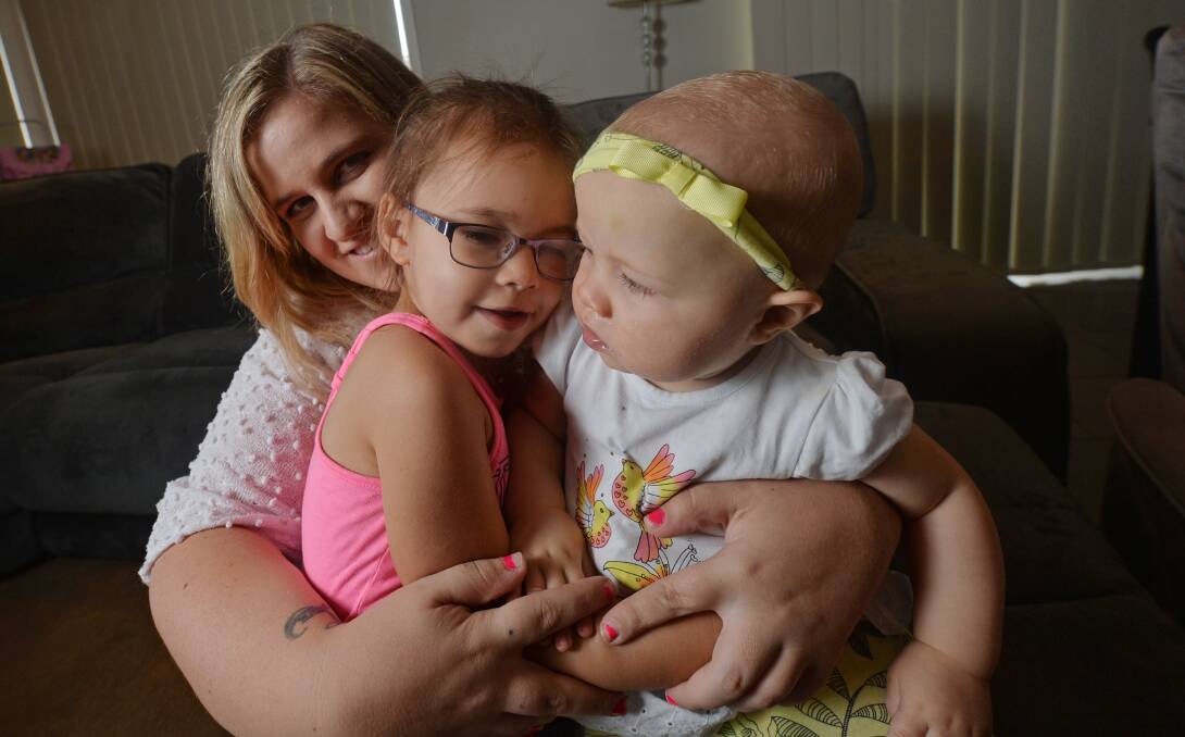HOPE: Mother Skye Whiteman cuddles up with her daughters Allyrah, 4, and Brydee, 1, who has a rare form of leukaemia. Picture: DARREN HOWE