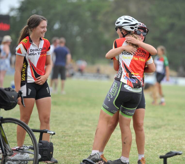 AT LAST: Friends embrace after completing the challenging cycling event. Picture: NONI HYETT