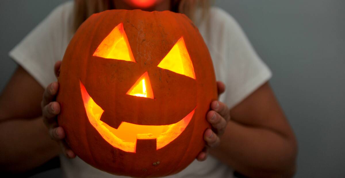 AGLOW: Lucy Dickson's lantern is all lit up ready for trick or treat at Halloween. Picture: NONI HYETT