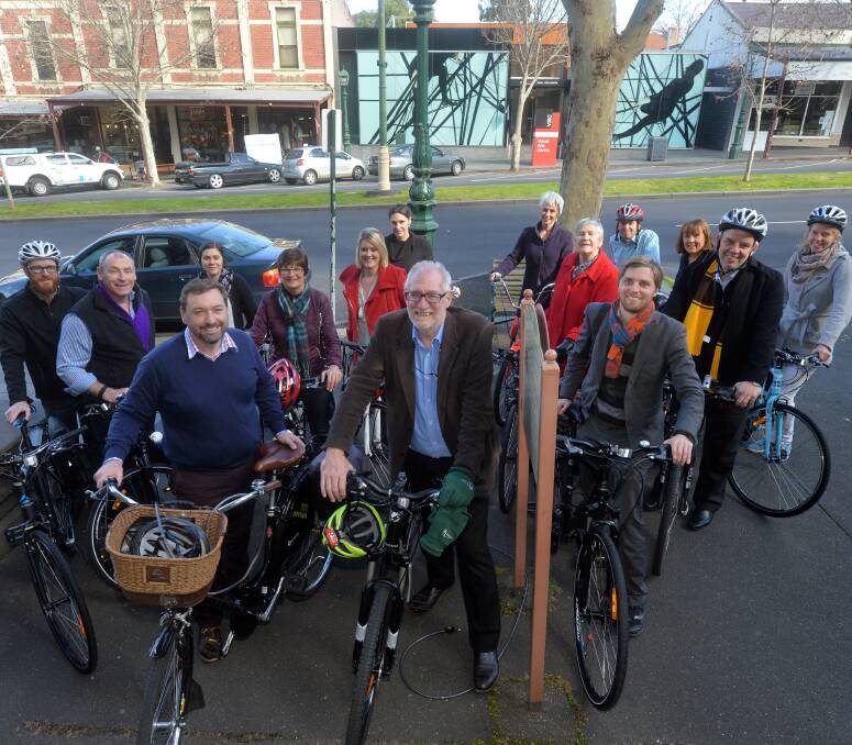 ON YOUR BIKE: Phil DeAraugo and Trevor Budge (front) lead a pack of council workers on a meandering bike ride through Bendigo's CBD. Picture: BRENDAN McCARTHY.