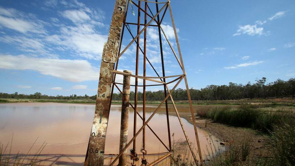 BONE DRY: A muddy puddle is all that is left of Wedderburn's Skinners Flat Reservoir. Pictures: GLENN DANIELS