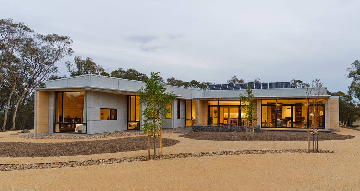 ECO-FRIENDLY LIVING: This Barkers Creek home in Central Victoria uses 100 per cent solar power generated by the panels on the roof and natural building materials (rammed earth and Barestone cladding) were selected for their low embodied energy and economical cost.

