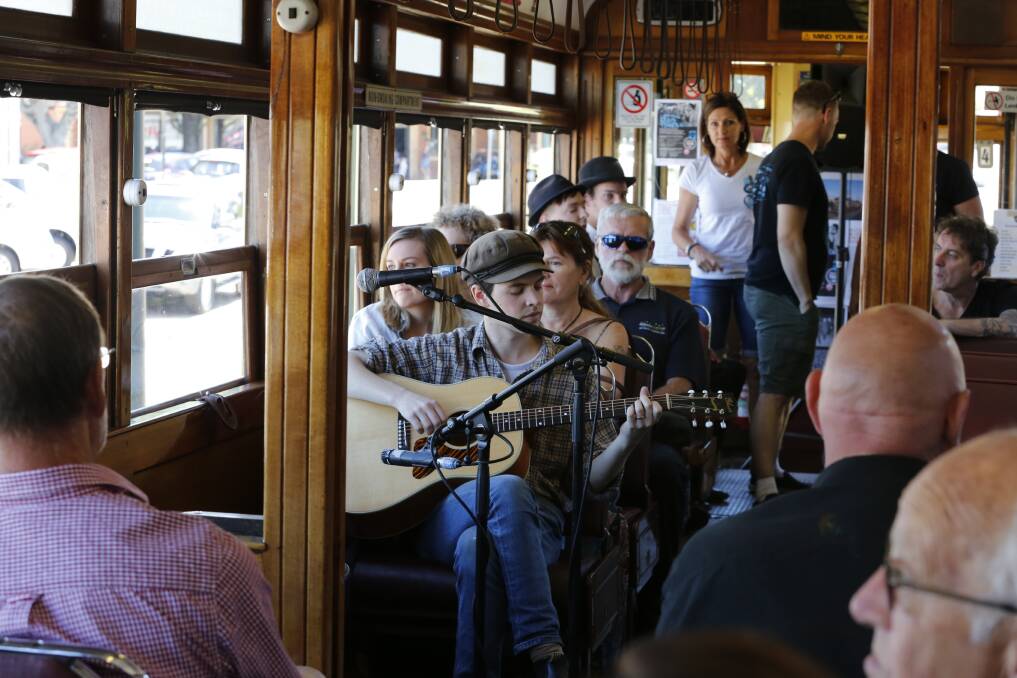 TRAM TUNES: Folk musician and songwriter William Alexander gets the first Blues Tram of 2017 in motion as it departs from Central Deborah Goldmine. Picture: EMMA D'AGOSTINO