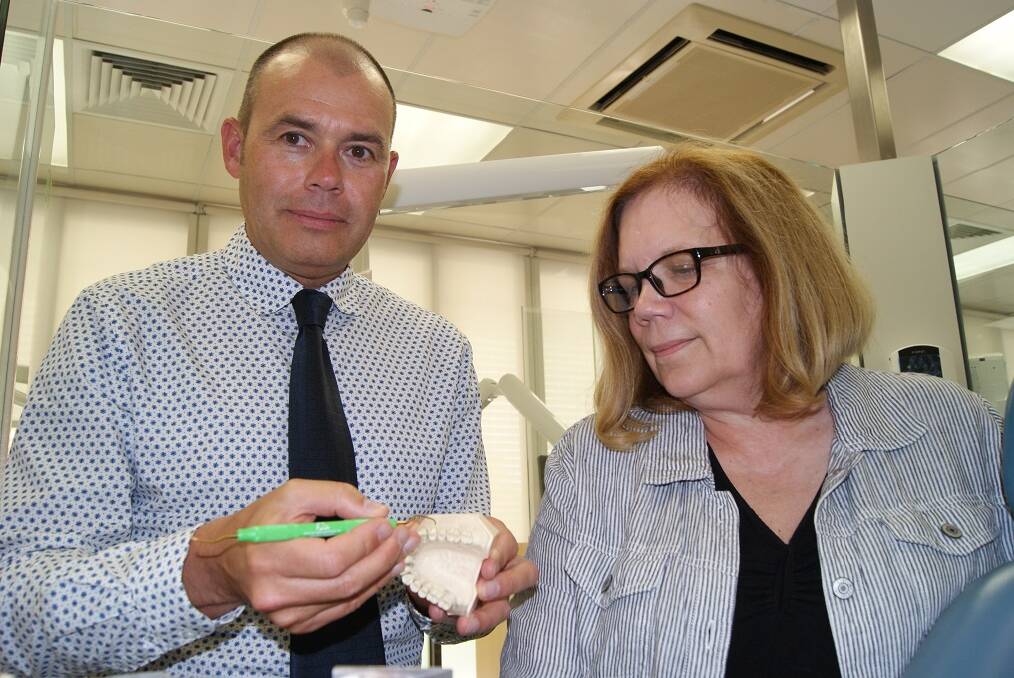 GRIP IT: Ron Knevel and Michelle Hurlbutt demonstrating the correct grip to hold dental and oral hygiene equipment at Latrobe University Bendigo. Picture: ANTHONY PINDA