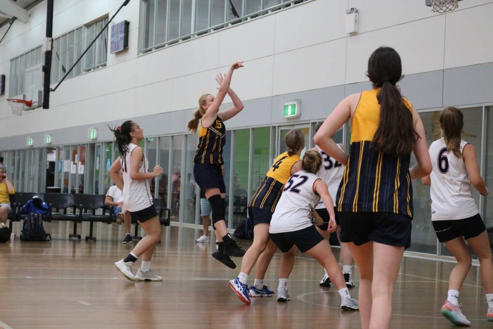 Catherine McAuley College's Piper Dunlop takes a shot.