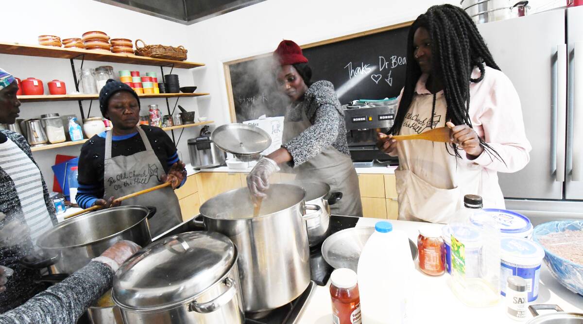 LUNCH TIME: Members of the South Sudanese community preparing lunch for the Loddon Campaspe Multicultural Services women's lunch. The event was held on World Refugee Day. Picture: DARREN HOWE