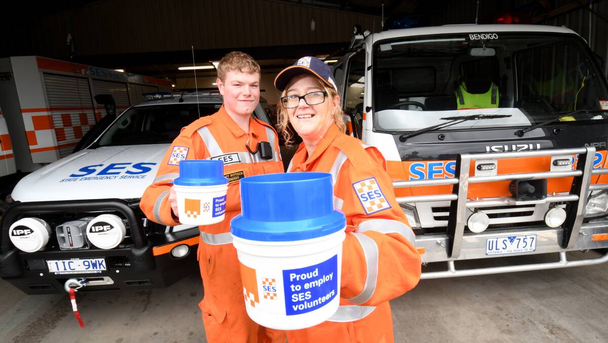 TIN RATTLE: SES members Donna McNeil and Matt Pittock with a new truck raised from fundraising and an old truck they hope to replace with fundraising. Picture: DARREN HOWE