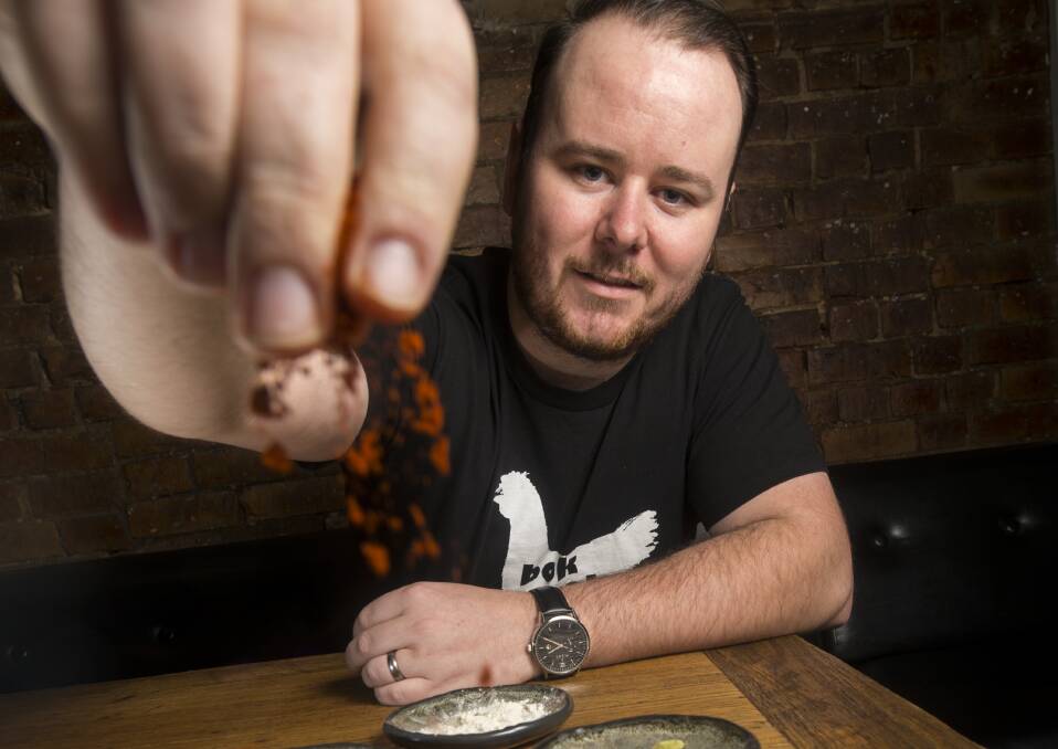 SPICY: Justin McPhail shows off a selection of spices he uses in his chicken curry. Picture: DARREN HOWE
