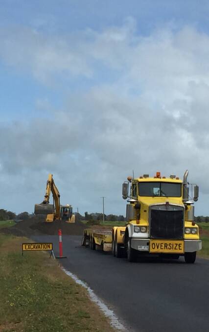 DIVERSION: Crews construct the temporary flood way on Back St Arnaud Road yesterday. It is the second temporary flood way the council has constructed. 