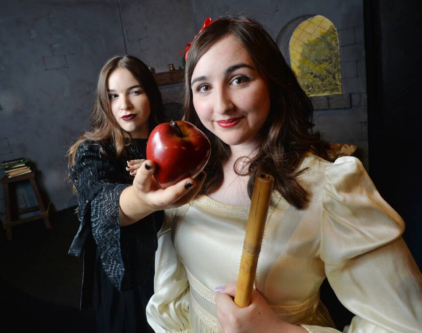 TEMPTATION: The Evil Queen (Melanie Thoren) offers a poisoned apple to the unsuspecting Snow White (Bronte Bailey). Picture: DARREN HOWE