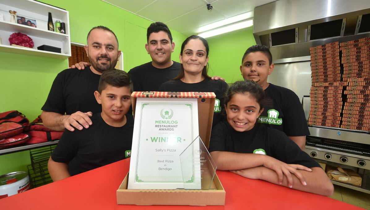 TOP SPOT: MenuLog has named Sally's Pizza the best in Bendigo. Owners John and Kate and John Kabalan, with their children Alex, Charlie, Chantelle and Paul, celebrate the announcement. Picture: NONI HYETT