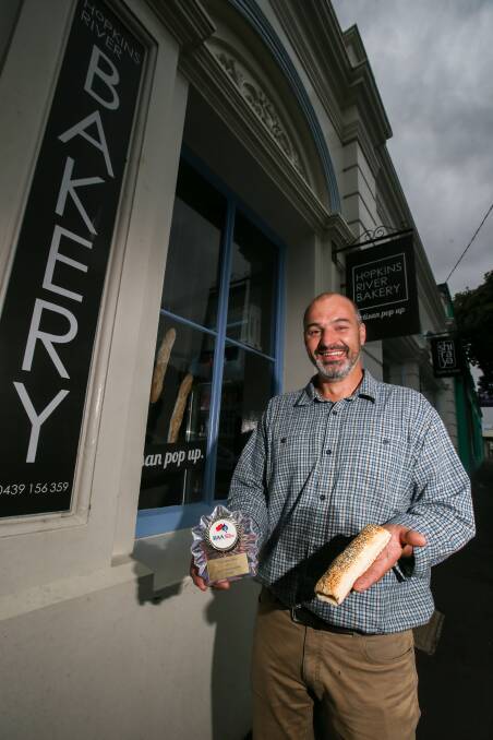 BEST: Chitticks Bakery operations manager Wally Steere at Hopkins River Bakery with the first place sausage roll and the award for the win. Picture: Amy Paton
