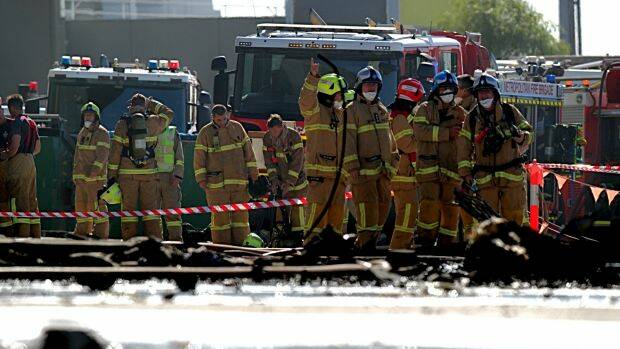 Firefighters at the scene of the plane crash at the Essendon DFO. Picture: JASON SOUTH
