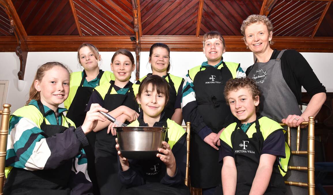 BRIGHT FUTURES: Specimen Hill Primary School students learn about commercial cookery from Cafe Essence owner Mynette Richardson under a careers program. Picture: NONI HYETT