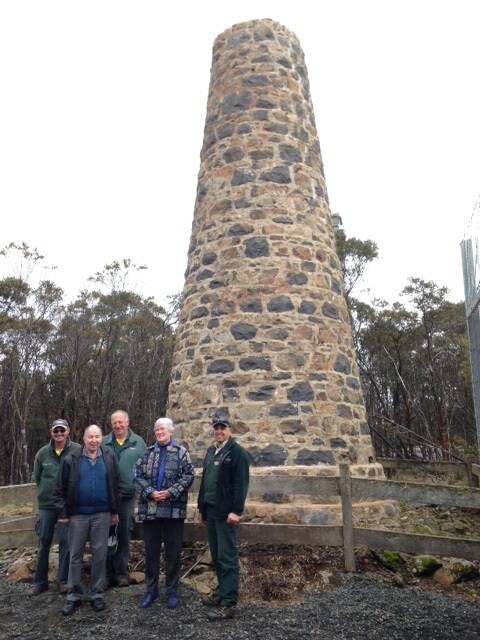 RESTORED: Parks Victoria Rangers Clive Lowe, Phillip Ginnane and Angelo Keratianos with Gisborne and Mount Macedon Districts Historical Society members Ian and Phyllis Boyd at the restored cairn.