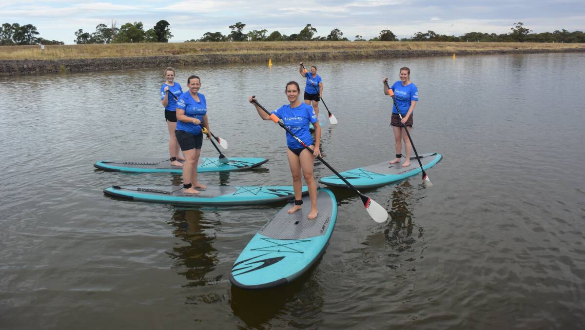 ON THE WATER: Raquel Spence, Camille White, Emma Healion, Colleen McCarthy and Amy Russell have learnt how to paddleboard under a government initiative aiming to get more women active.