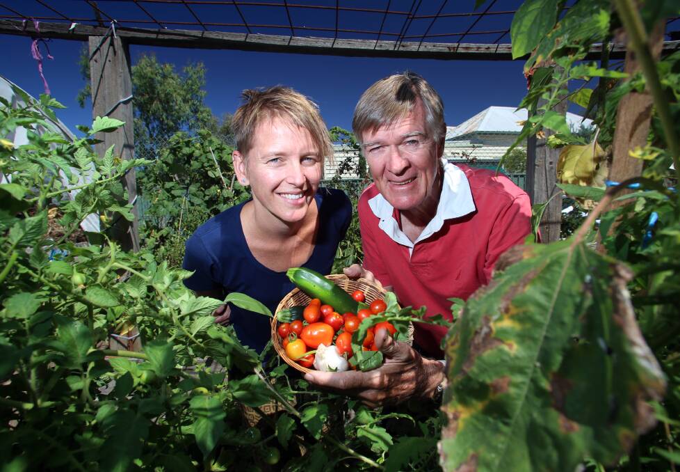 FOOD AND FUN: Kylie Martens from the Hope... It Grows! community garden and cooking group participant Larry Kern collect some fresh produce. Picture: GLENN DANIELS