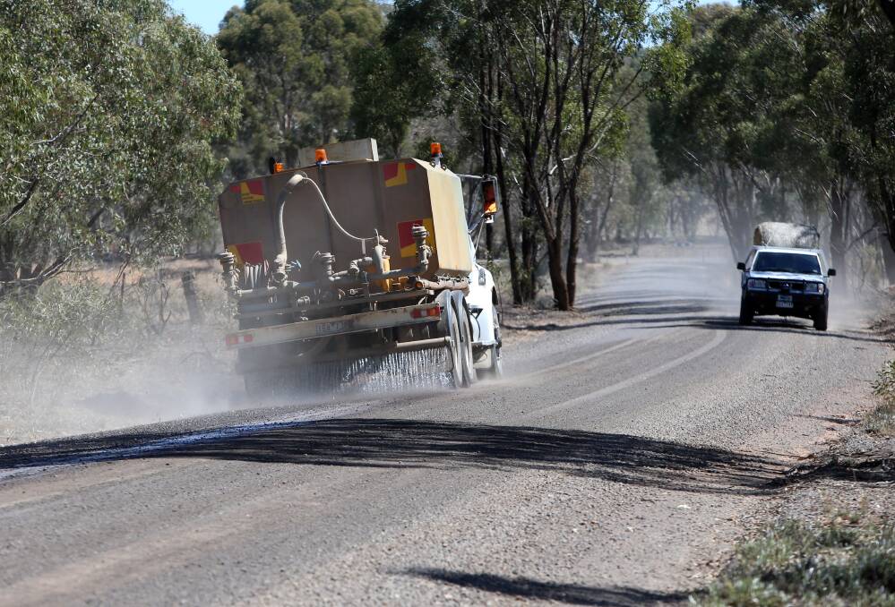 ISSUE: A truck sprays water along McKinnons Road, one of two roads flagged as problematic by residents. Picture: GLENN DANIELS