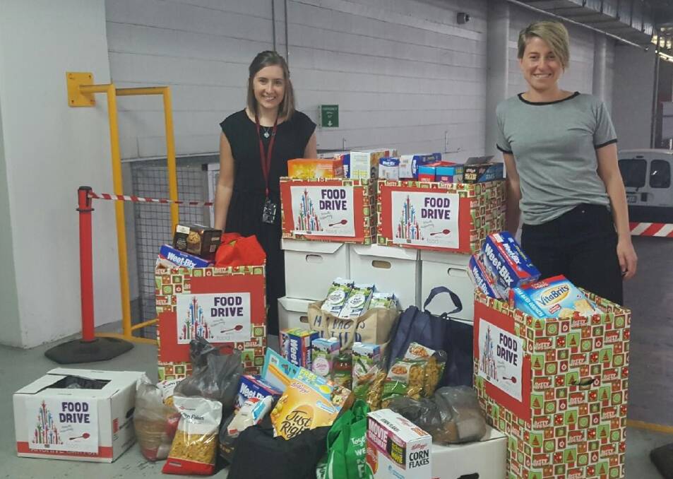 GENEROSITY: Bendigo and Adelaide Bank staff members Abby Anderton and Jess Sloane, who helped co-ordinate the food drive with colleagues.