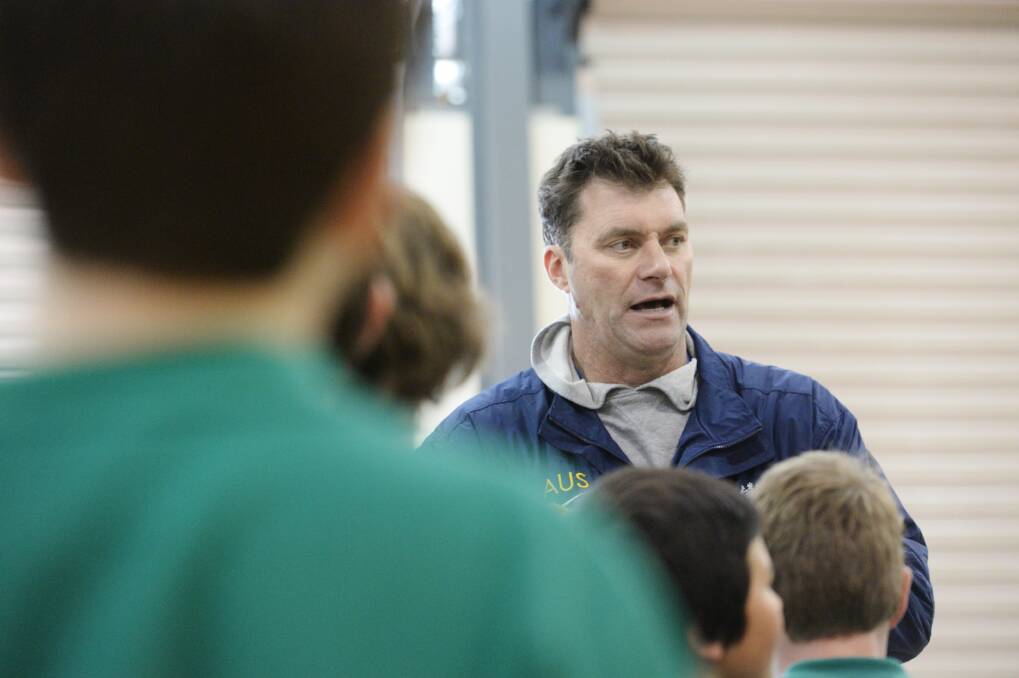 Mark Bradtke passes on some basketball tips during an active youth development program at St Liborious Primary School in Eaglehawk.