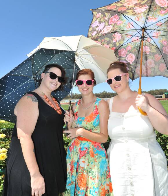 DRY FEBRUARY: Bridge Scilini, Megan Beagley and Eleanor Boswell needed umbrellas last month, but not to keep them dry from the rain. Picture: NONI HYETT
