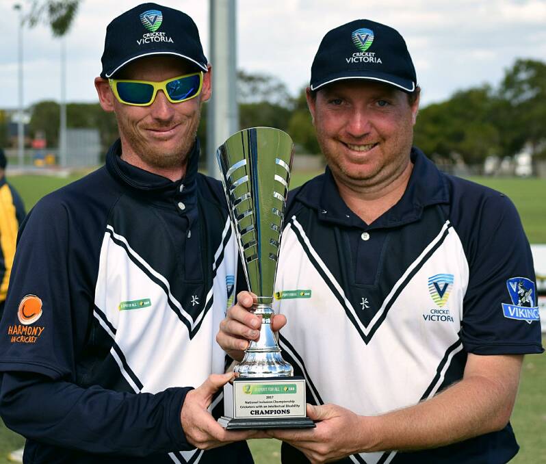 Ben Kenyon and Zachary Taig with the championship trophy won with the Victorian Vikings at the National Cricket Inclusion Championships in Geelong last week.