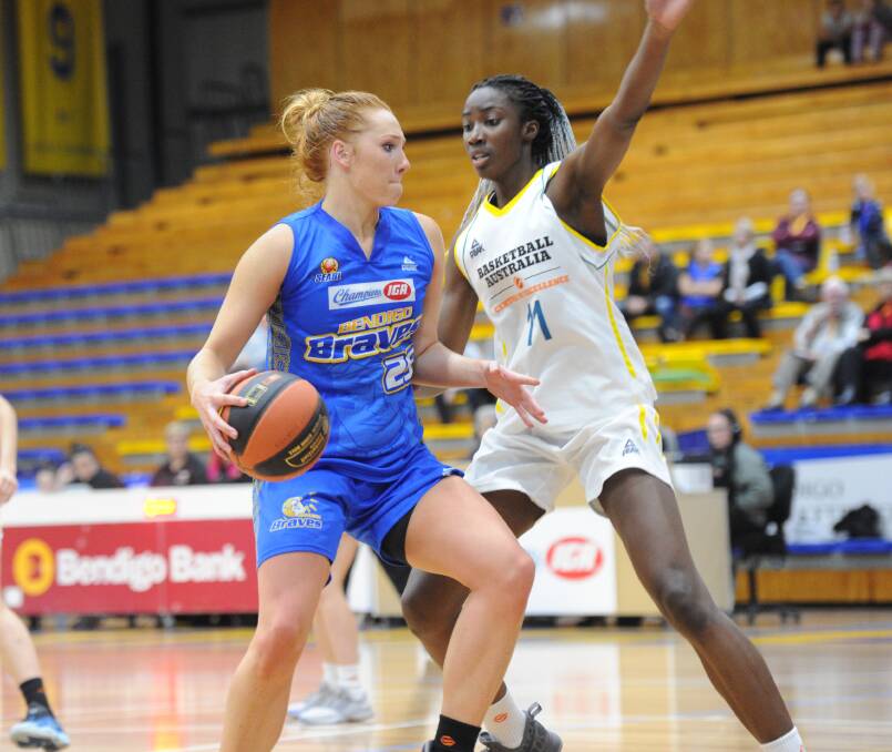 YOUNG GUNS: Bendigo Lady Braves star Chloe Bibby looks for a way around talented Basketball Australia Centre of Excellence centre Eziyoda Magbegor. Picture: NONI HYETT