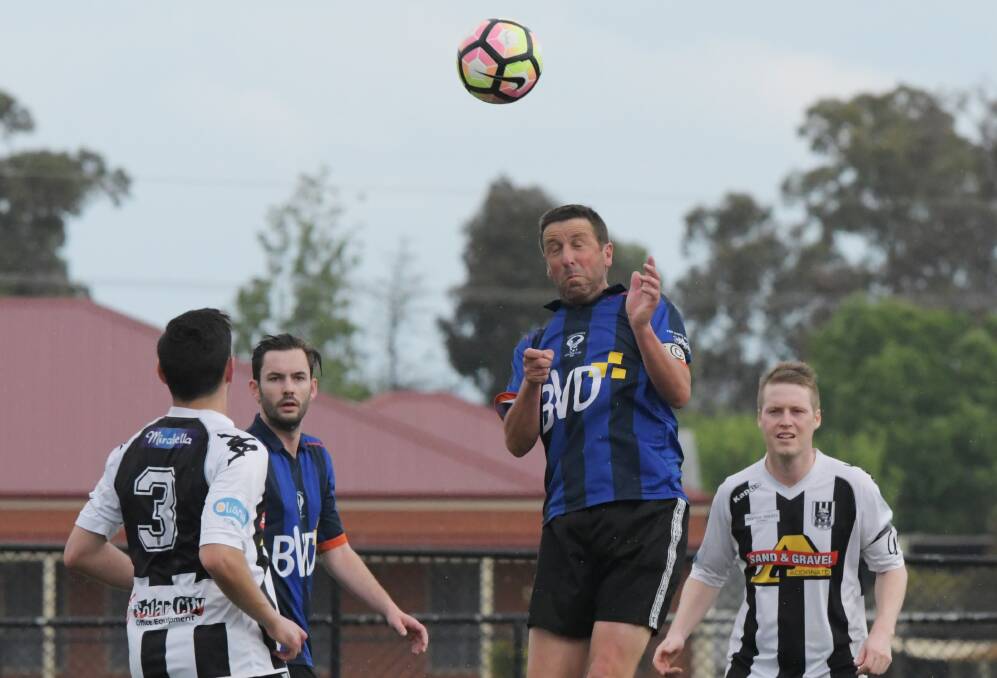 Greg Thomas gets his head to the ball in Sunday's grand final. Picture: DARREN HOWE