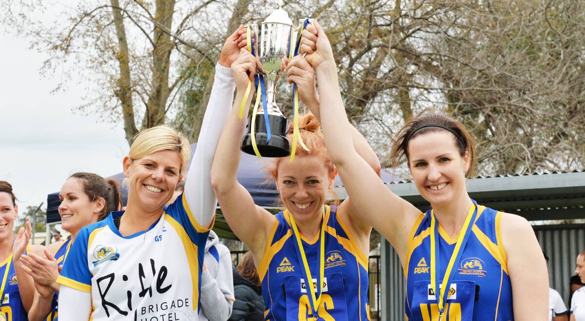 THREE-IN-A-ROW: Golden Square A-reserve coach Kendyl Hopley and co-captains Jody Richards and Loz Ray with the A-reserve premiership cup. 