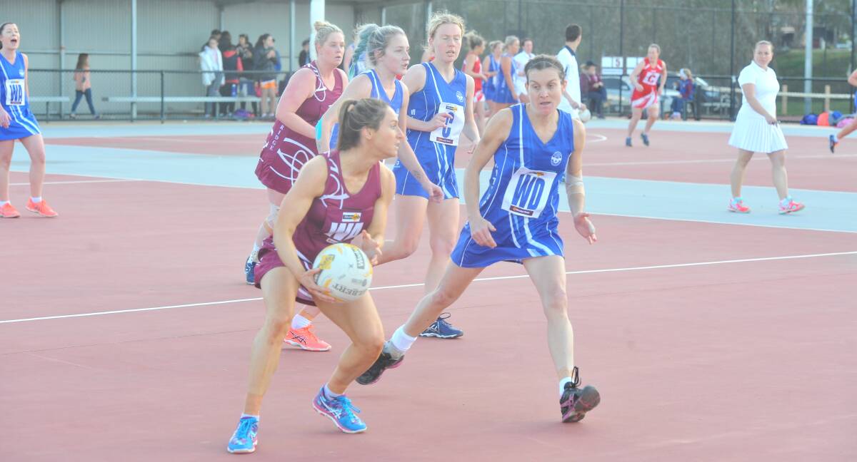 ATTACK: Newbridge's Danielle Dillon looks to propel the Maroons forward under pressure from Abbey Hay.