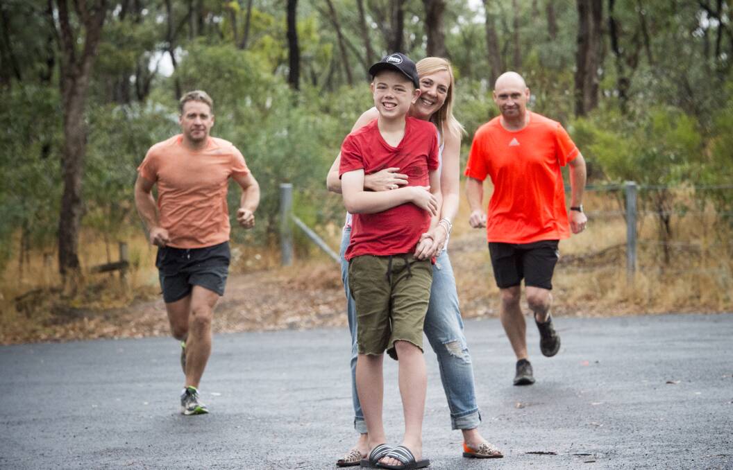 Runners Dan O'Bree and Travis Edwards, with Trudi Richardson and her son Elliott. The Bendigo men are running 100 kilometres to raise awareness and funds for autism.